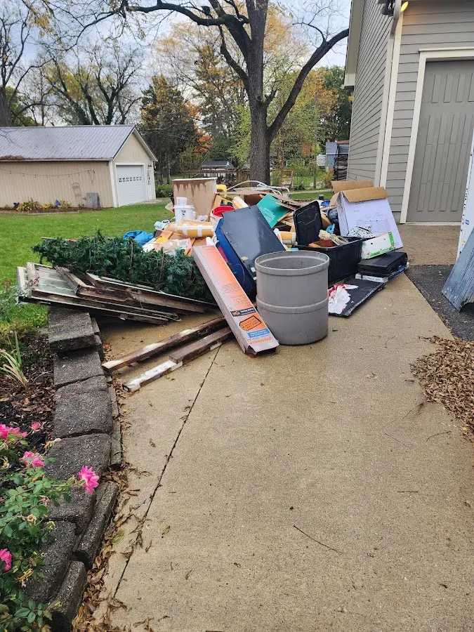 Dumpster being loaded with debris for Roofing Dumpster Rental in Cedar Hill